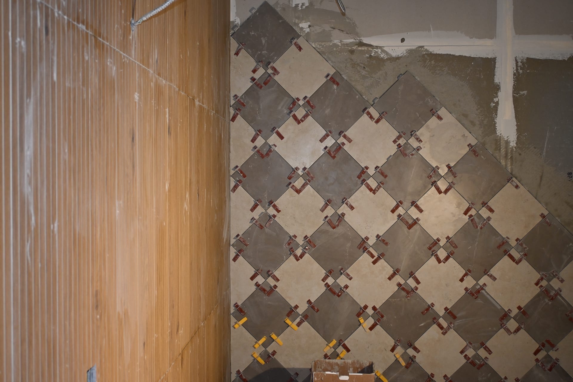 Wood accent wall and tile installation in progress